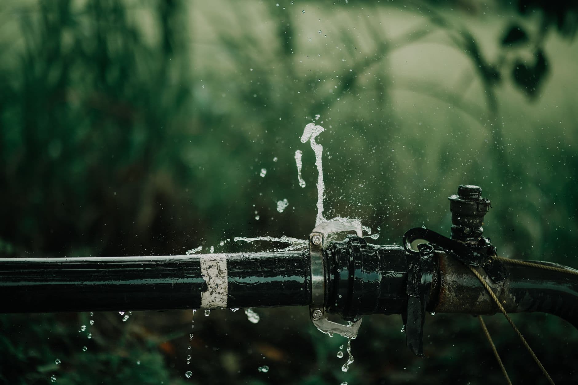 An open well with a technician performing a technical inspection and pumping.